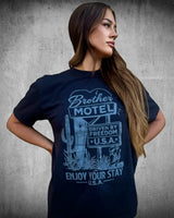 Woman wearing the Brother Motel Tee — retro Americana patriotic graphic t-shirt in black, 100% ring-spun cotton.